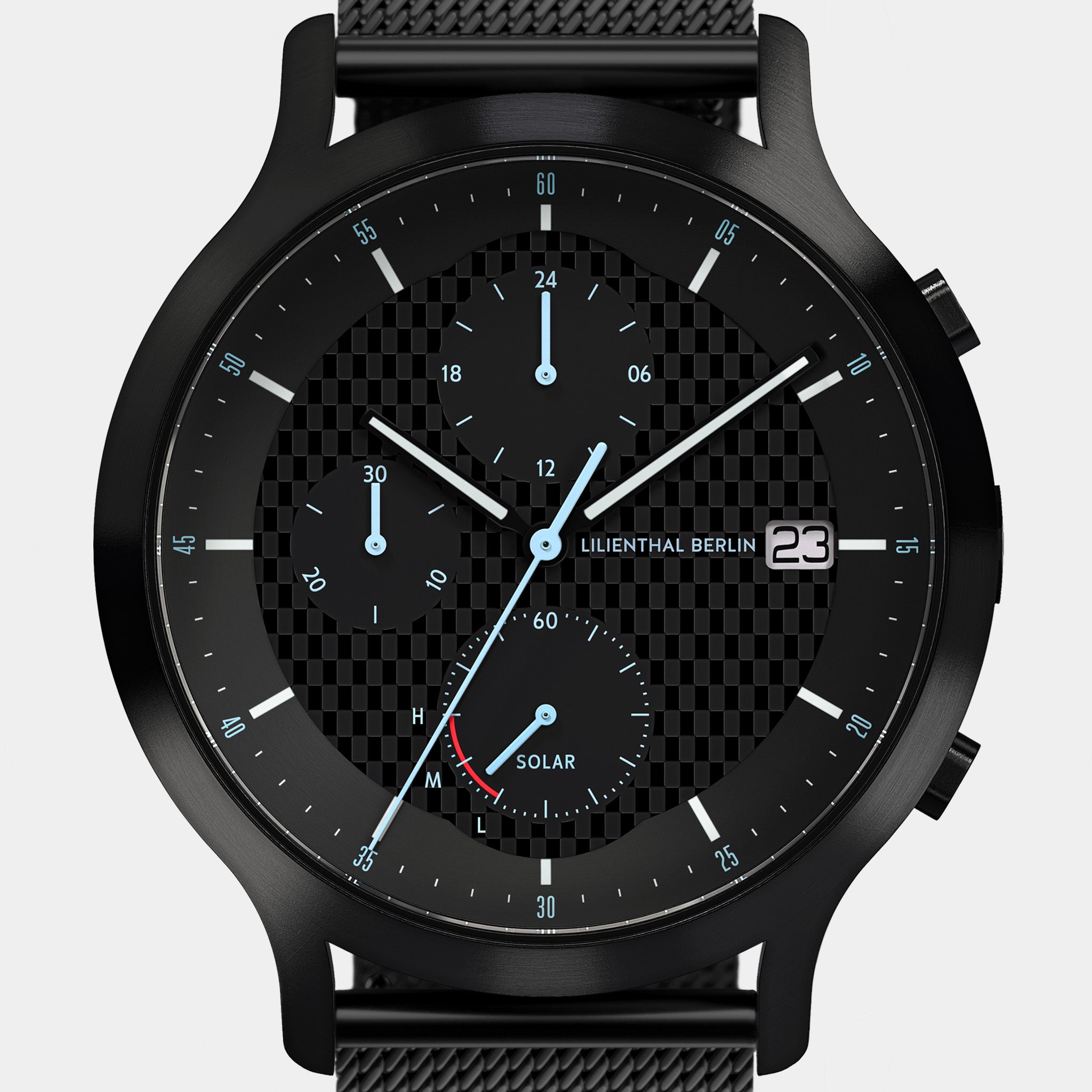 Black solar chronograph watch with mesh strap, checkerboard dial, and blue hands