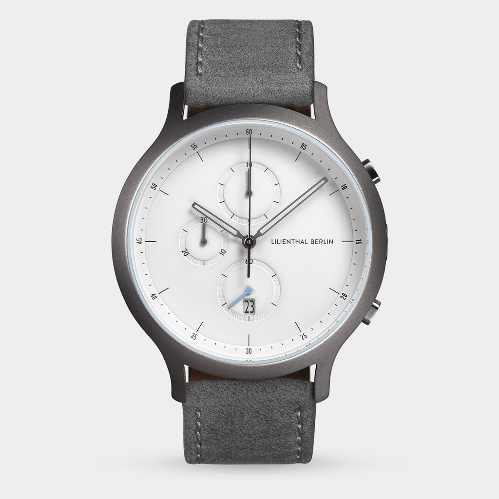 Minimalist men's chronograph watch with grey strap, white dial, and date display