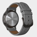 Back view of a stainless steel chronograph watch with grey leather strap
