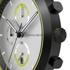 Minimalist chronograph watch with black case, white dial, yellow accents and visible subdials