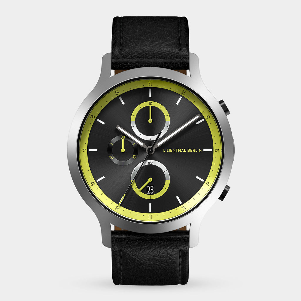 Men’s black chronograph watch with yellow accents, subdials, date display, and leather strap.