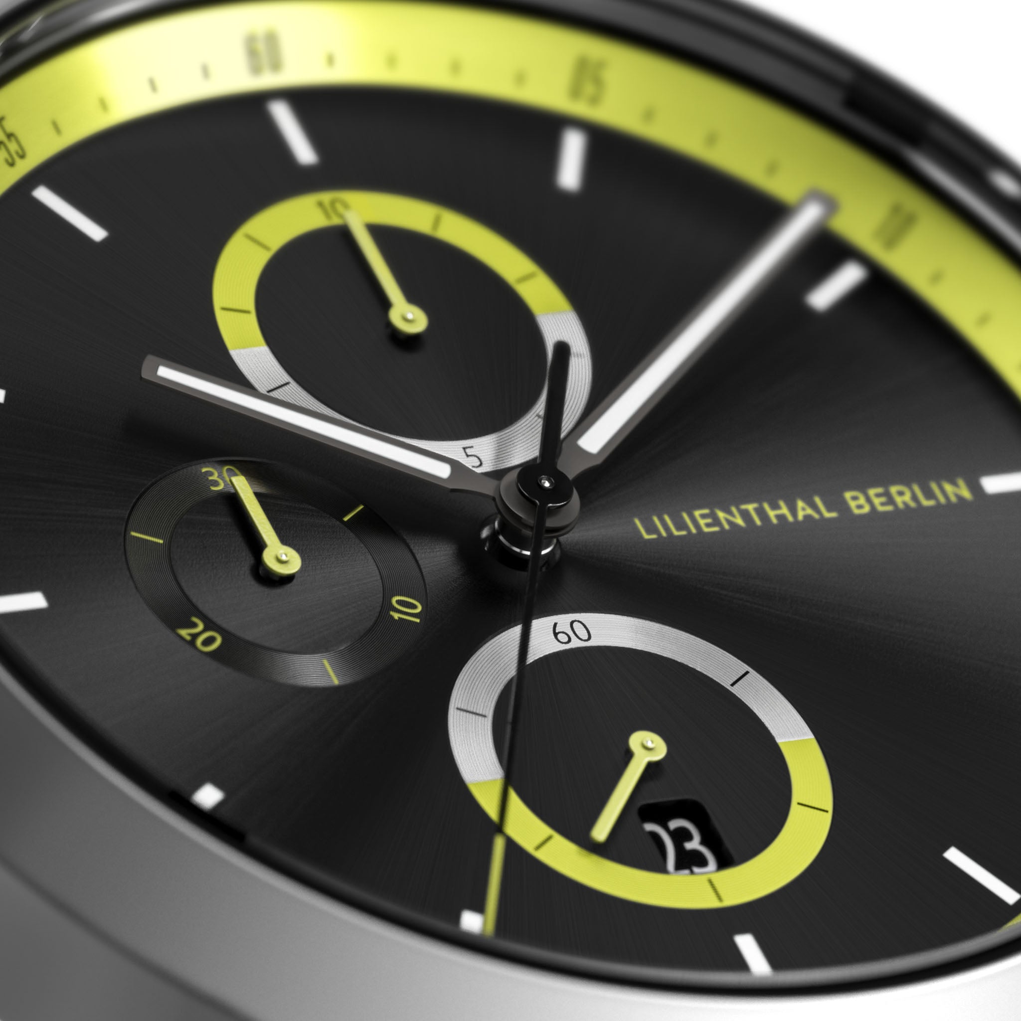 Close-up of modern black chronograph watch face with yellow accents and subdials
