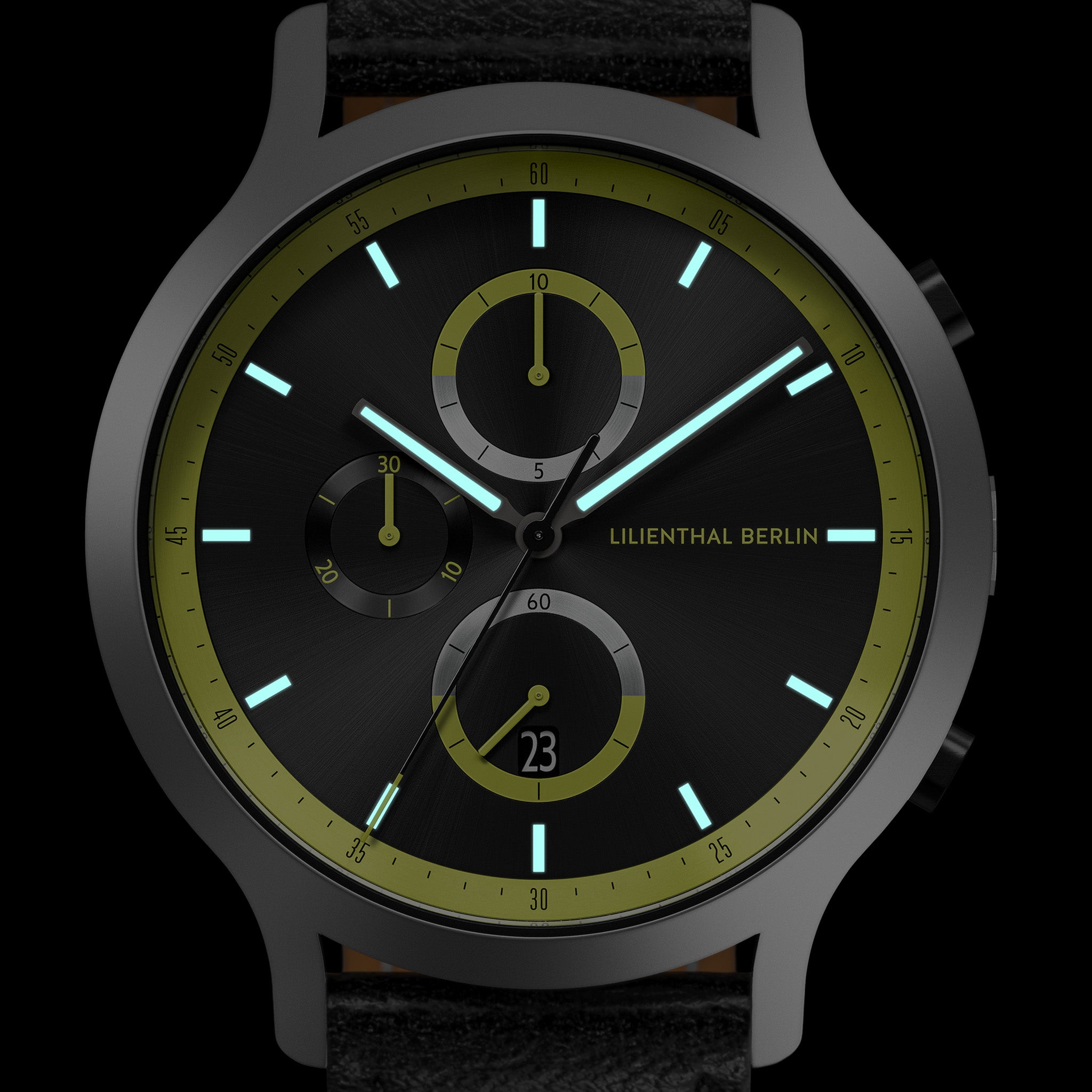 Black chronograph watch with green accents, luminous hands, subdials, and date display