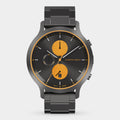 Modern chronograph watch with black metal band, black dial, and orange subdials.