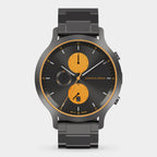 Modern chronograph watch with black metal band, black dial, and orange subdials.