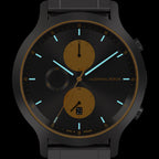 Black and gold chronograph wristwatch with luminous hands and date display
