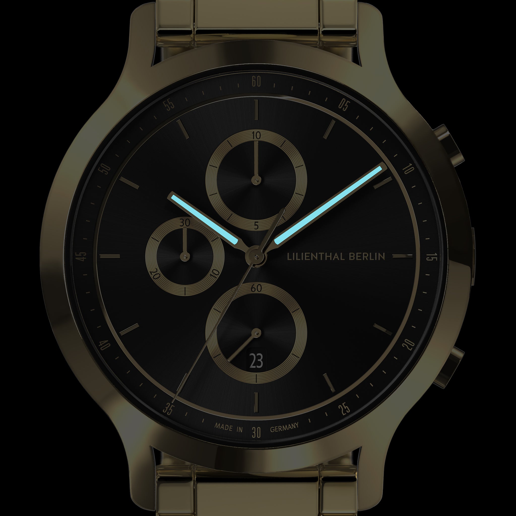 Black and gold chronograph watch with luminous hands and minimalist subdials