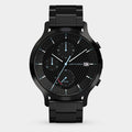 Black chronograph watch with solar dial, metal strap, and checkered black face