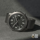 Minimalist black chronograph wristwatch with mesh strap and German Design Award 2024 badge.