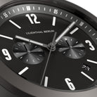 Close-up of a modern black chronograph watch face with subdials and date display