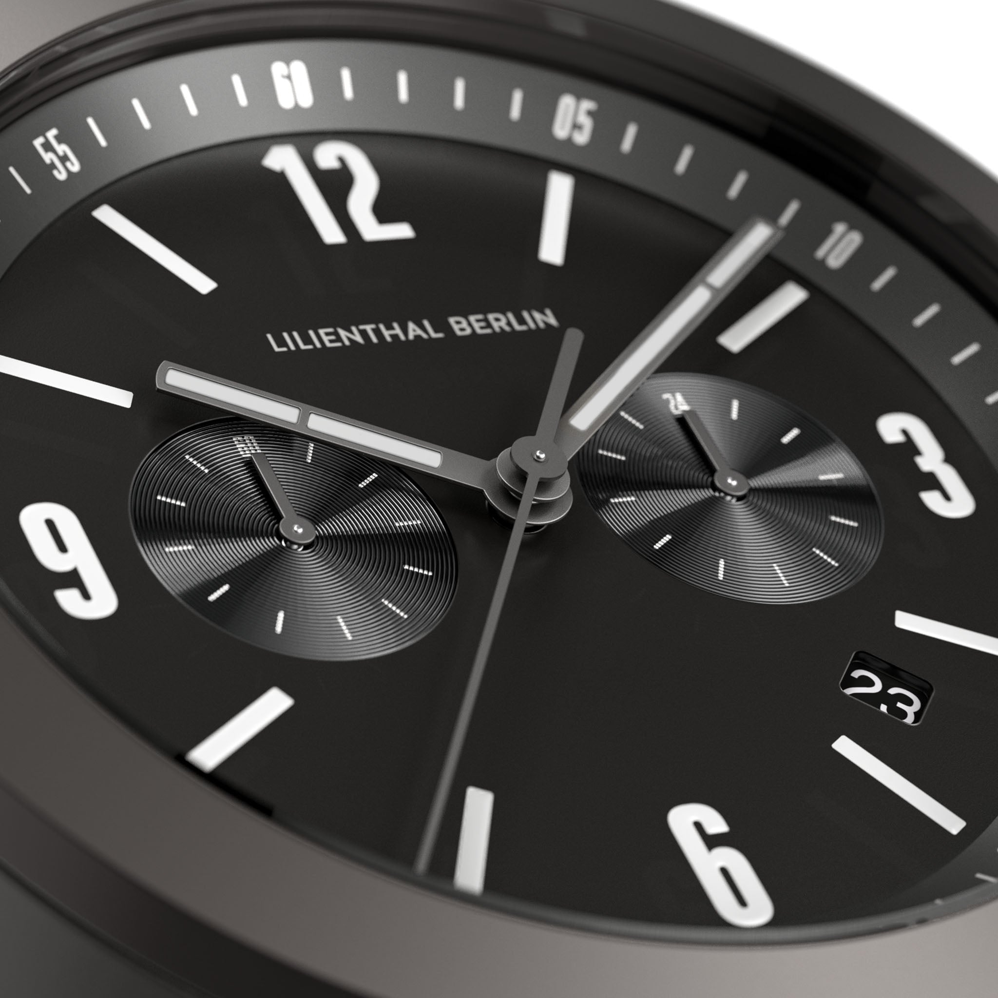 Close-up of a modern black chronograph watch face with subdials and date display