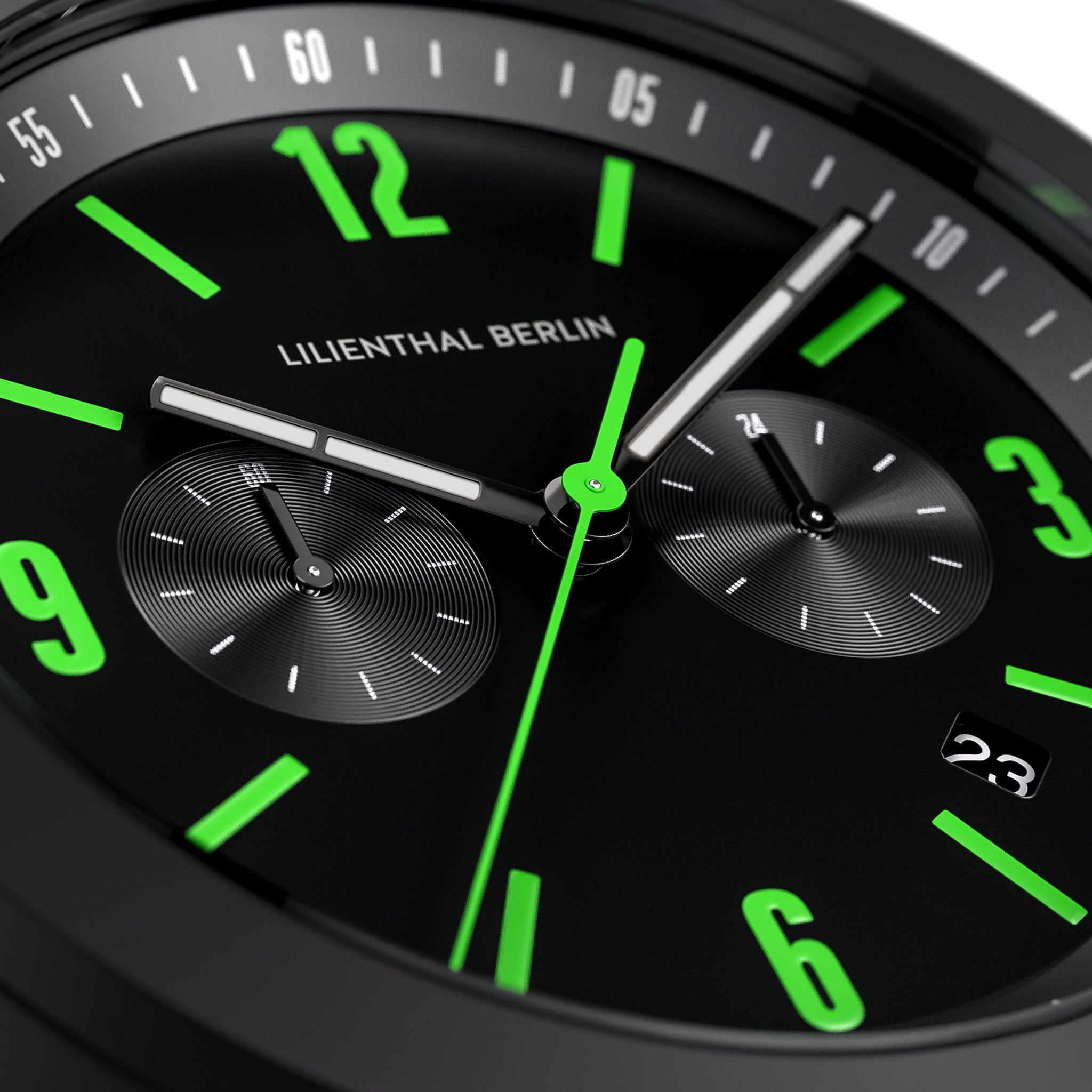 Close-up of modern black watch face with green numerals and chronograph subdials
