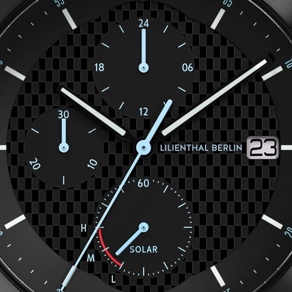 Close-up of chronograph solar watch dial with subdials, date display, and textured background