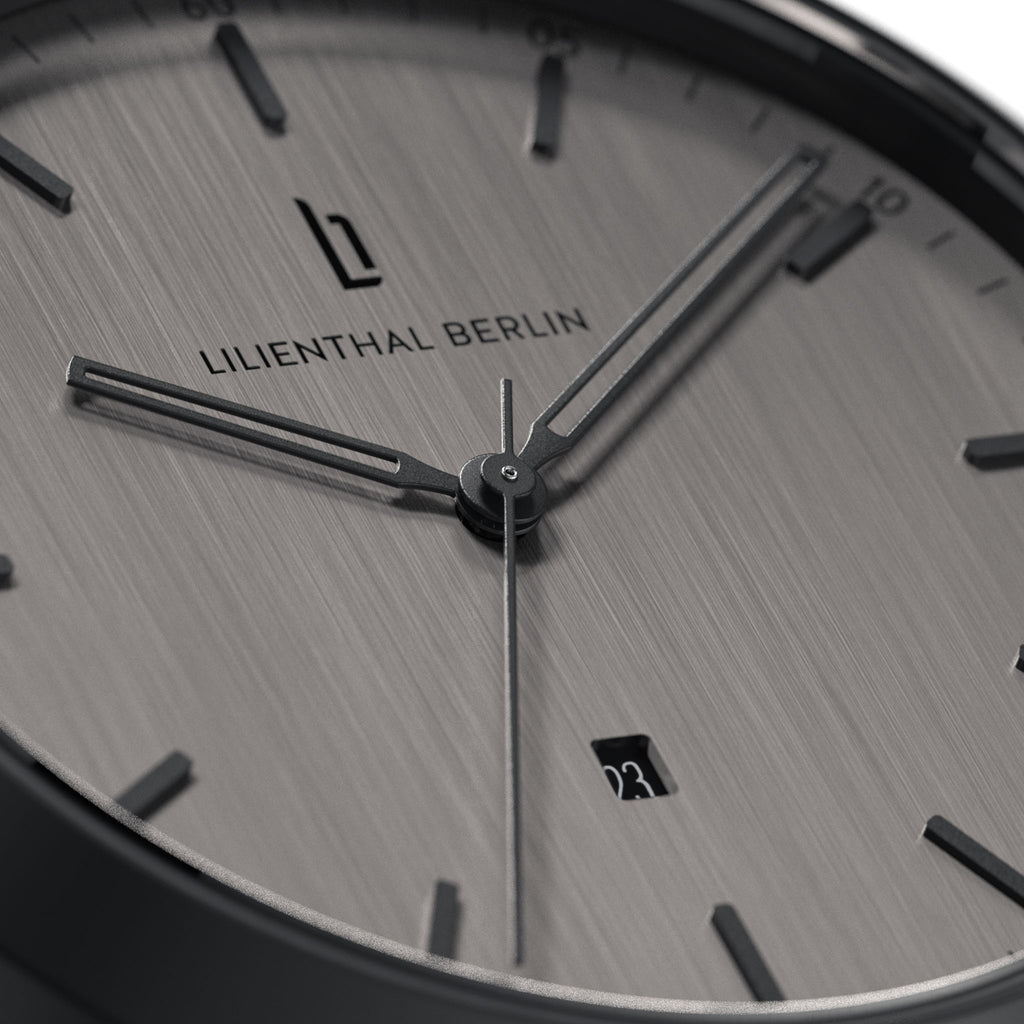 Minimalist silver analog watch face with date display and sleek hour markers