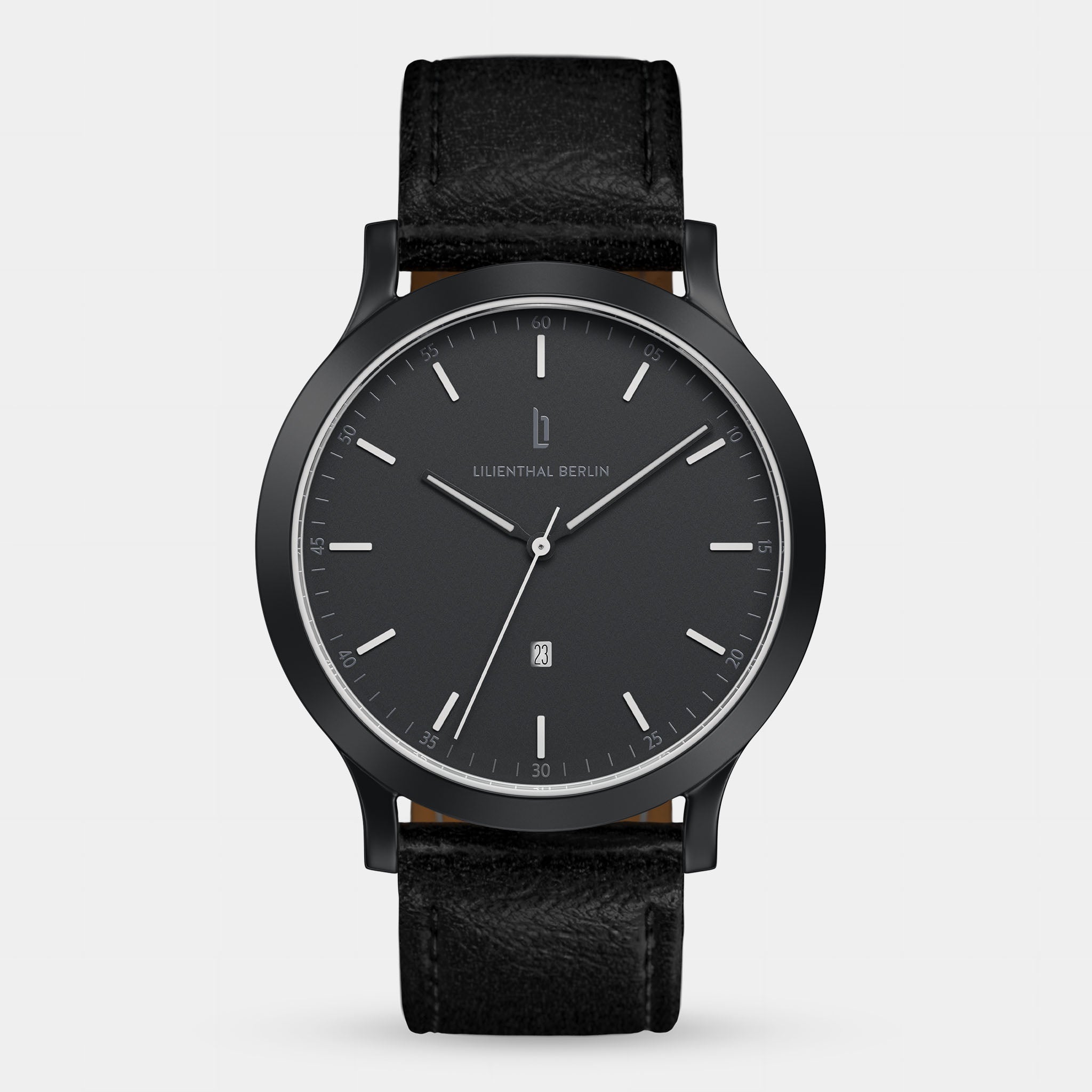 Minimalist black wristwatch with leather strap and date window, modern dial design
