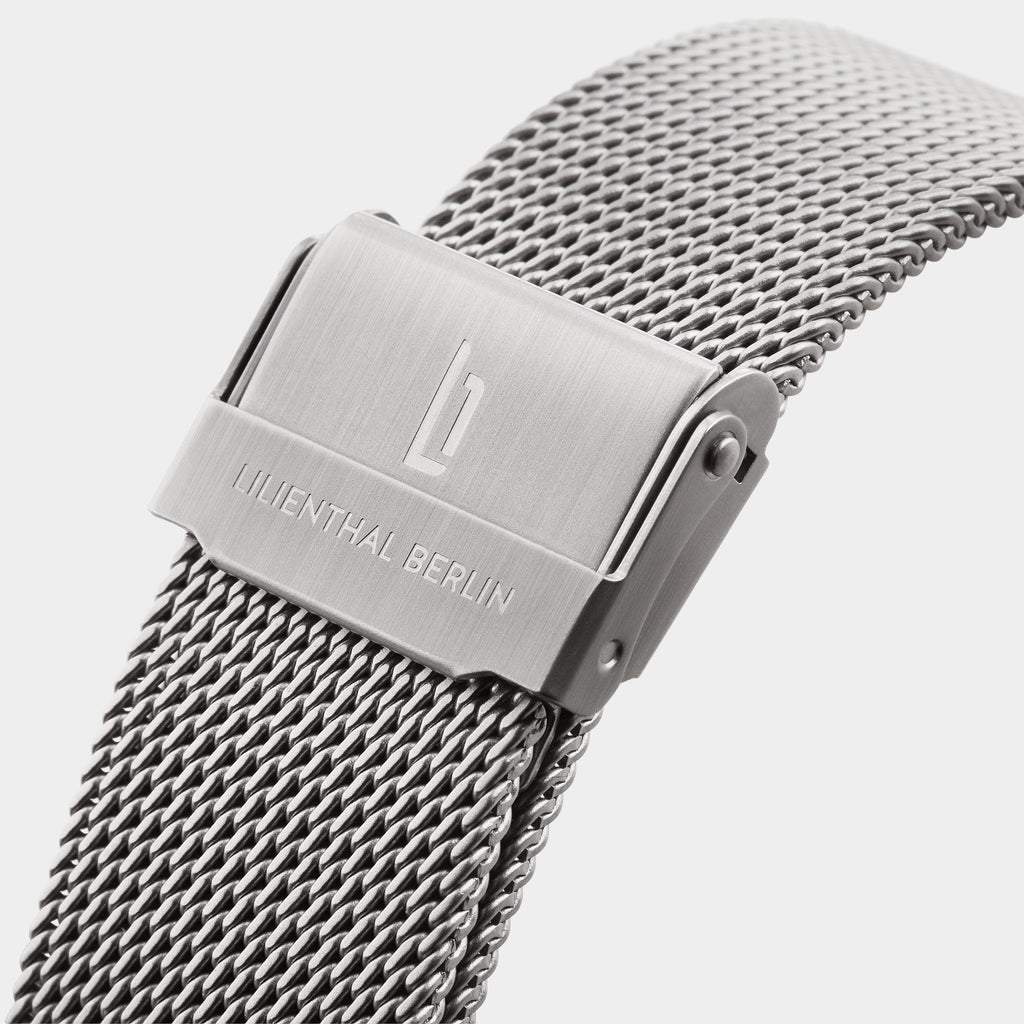 Stainless steel mesh watch strap with brushed clasp and engraved logo