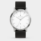 Minimalist silver wristwatch with white dial, black mesh strap, and date display