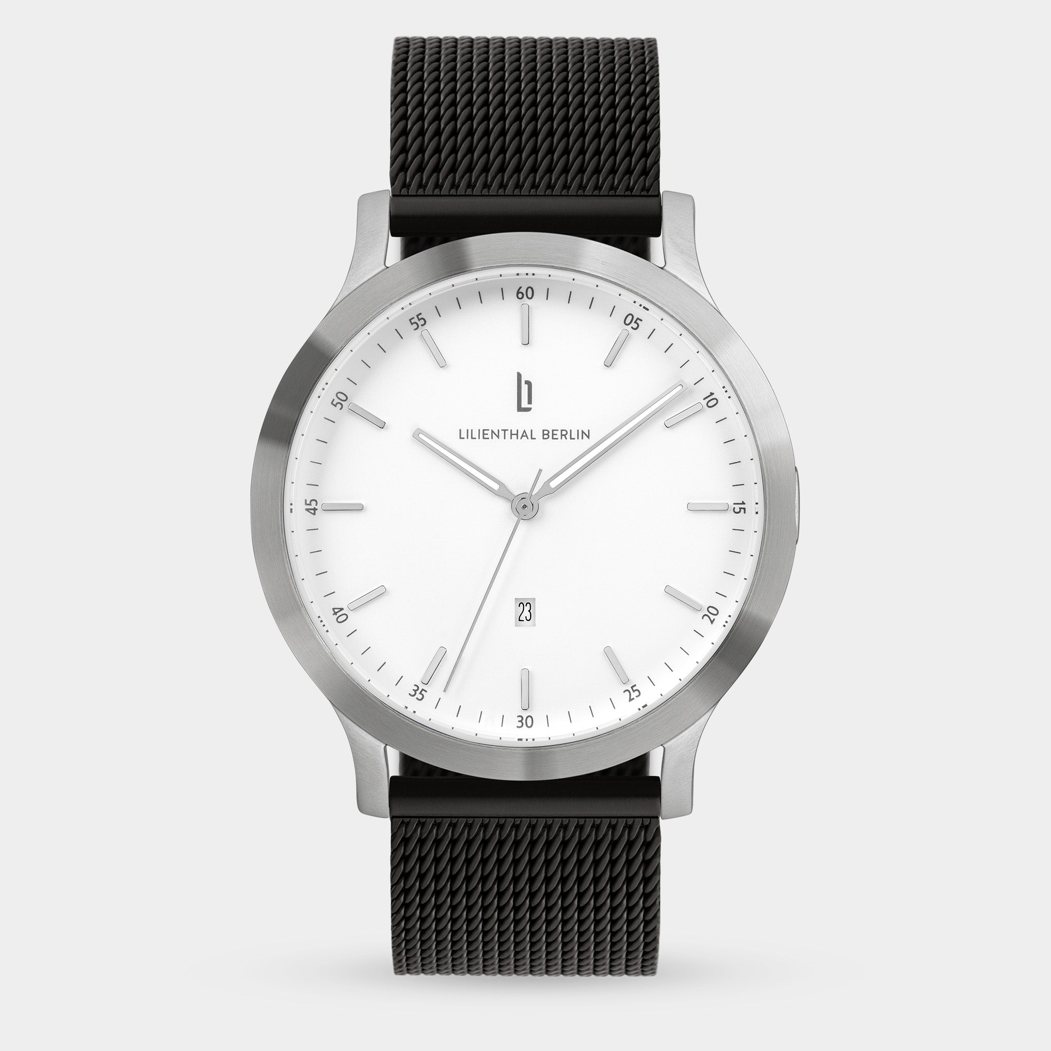 Minimalist silver wristwatch with white dial, black mesh strap, and date display