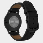 Back view of a black stainless steel watch with Huxley engraving and black leather strap