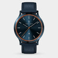 Elegant blue wristwatch with orange accents, leather strap, minimalist dial, date display