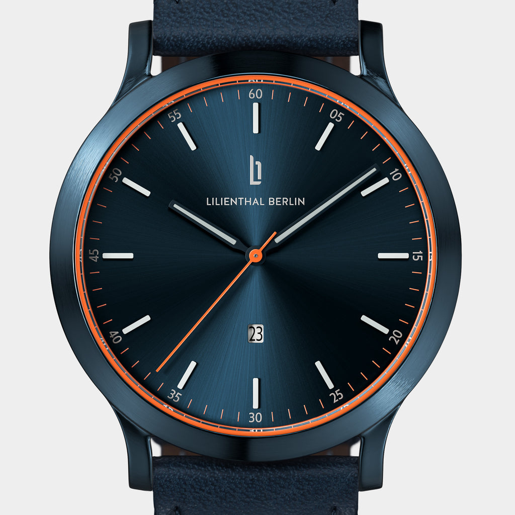 Sleek blue wristwatch with minimalist dial, orange accents, and date display