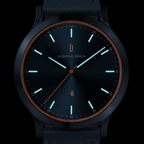 Minimalist black wristwatch with glowing hour markers, date window, and leather strap