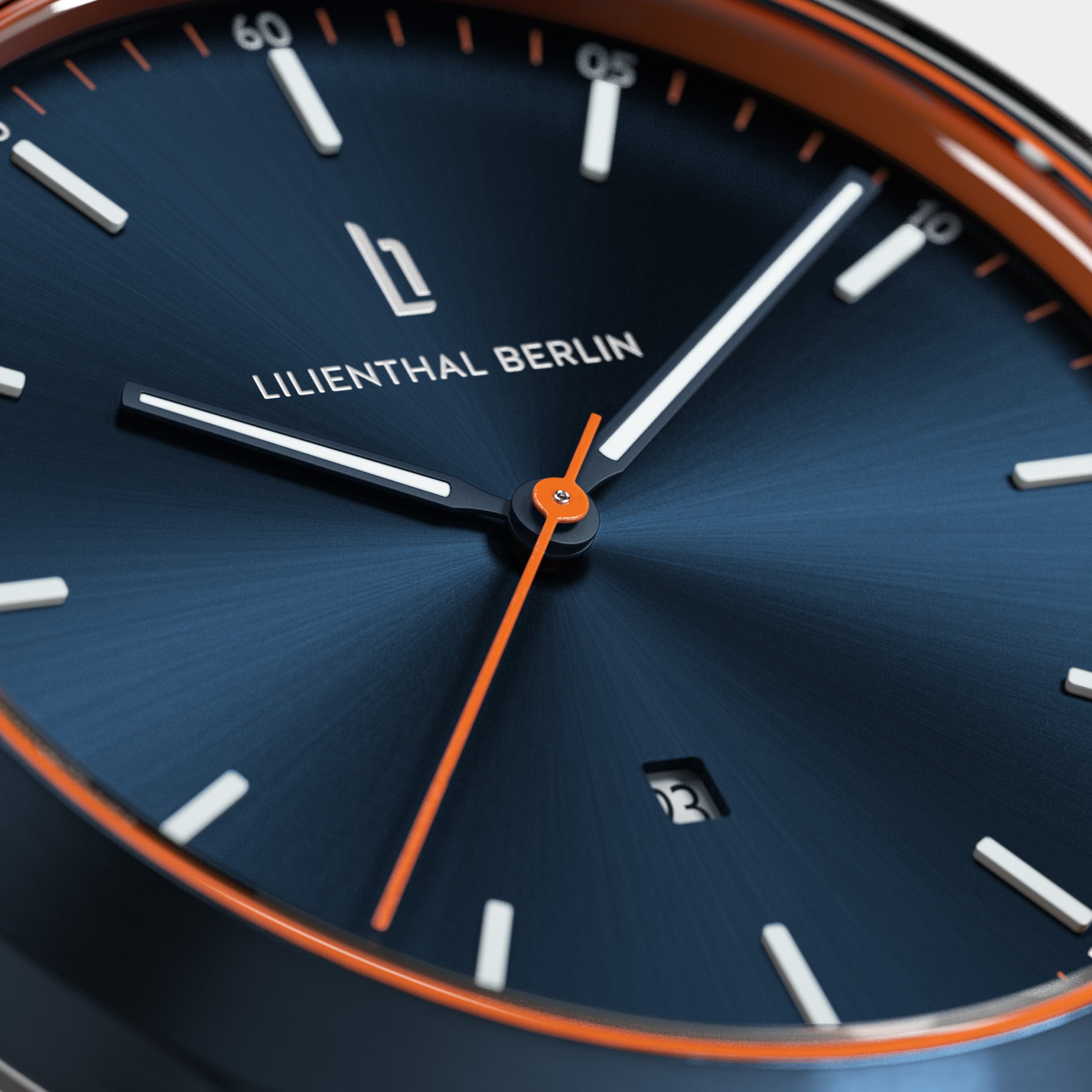 Close-up of a modern blue watch face with orange accents and a date display