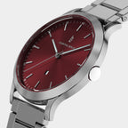 Silver wristwatch with a red dial and minimalist markers on a metal bracelet