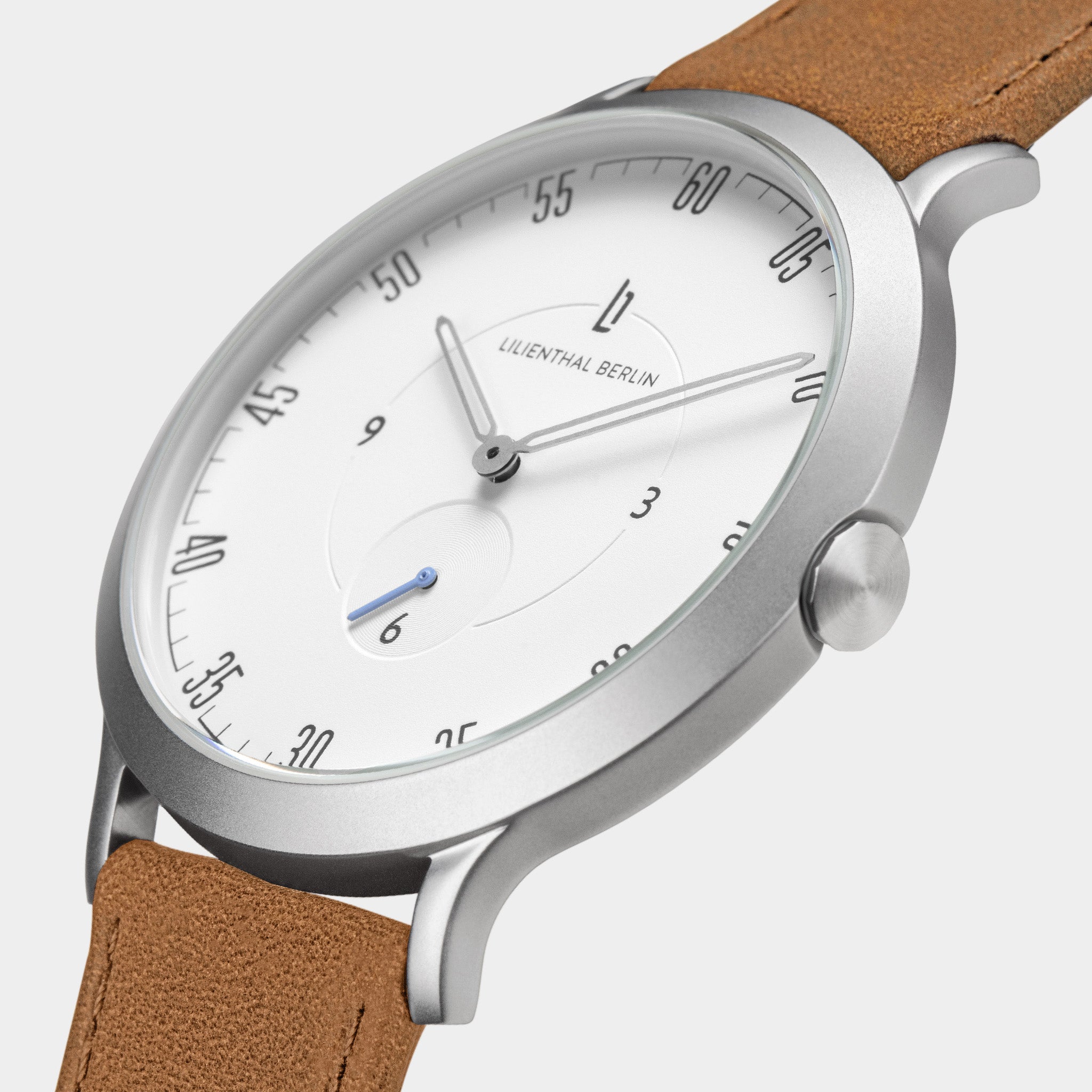 Minimalist silver watch with white dial, black markers, and brown leather strap