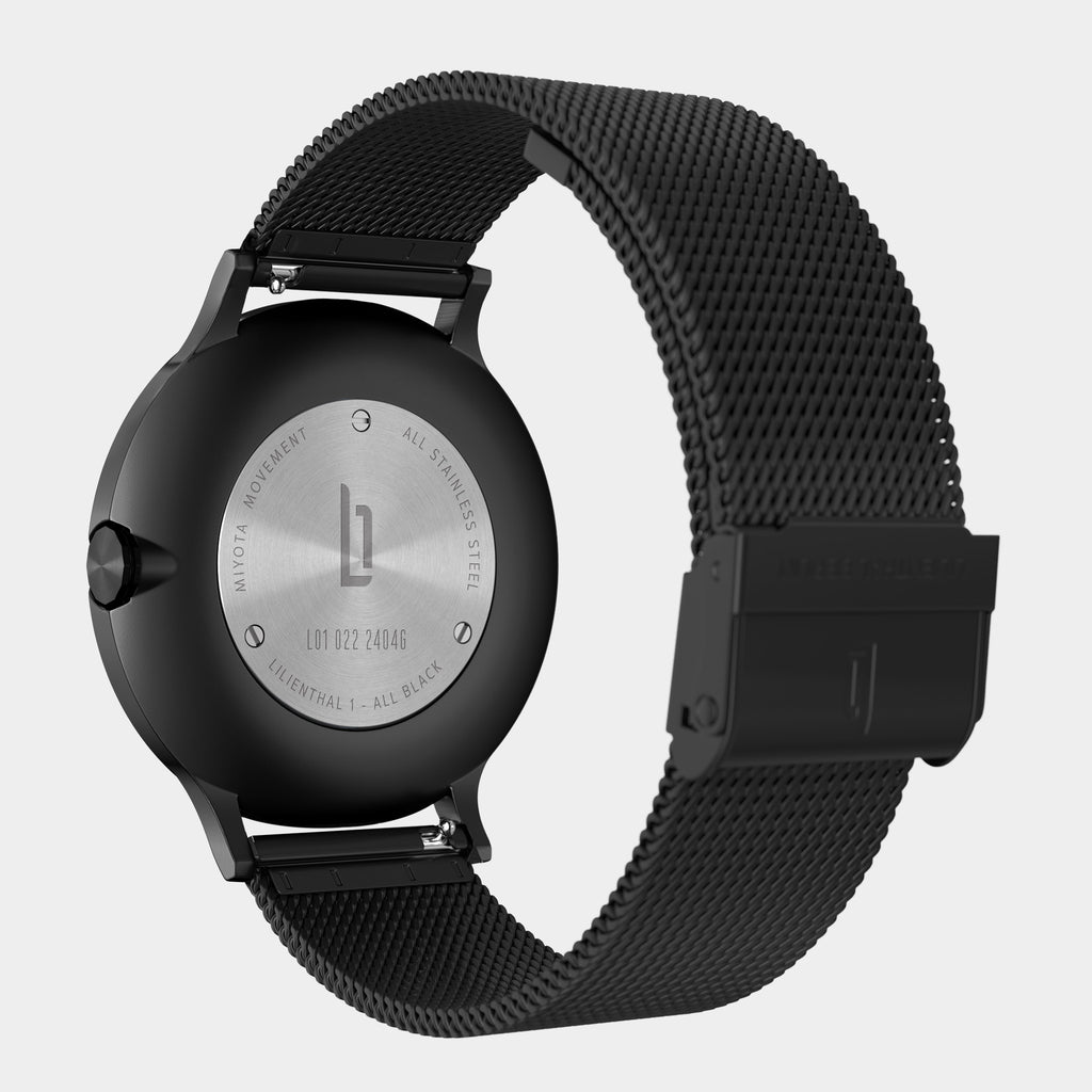 All-black mesh stainless steel watch with engraved case back and clasp, minimalist design