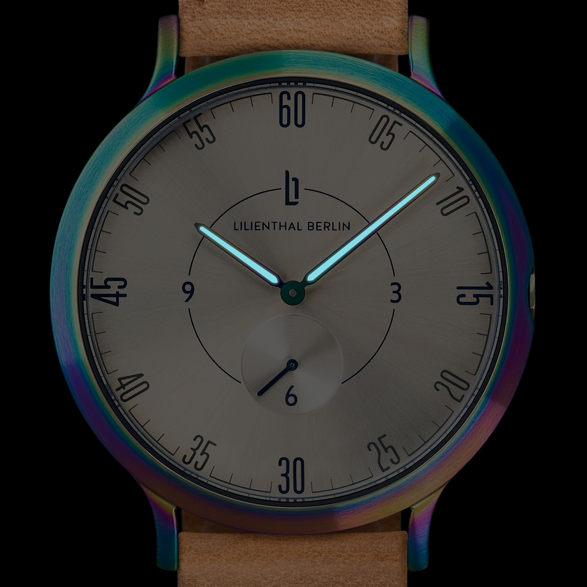 Minimalist wristwatch with luminous hands, brushed metal dial, tan leather strap, rainbow bezel